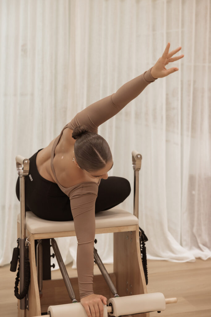 Dancer stretching using pilates equipment during dance physiotherapy.